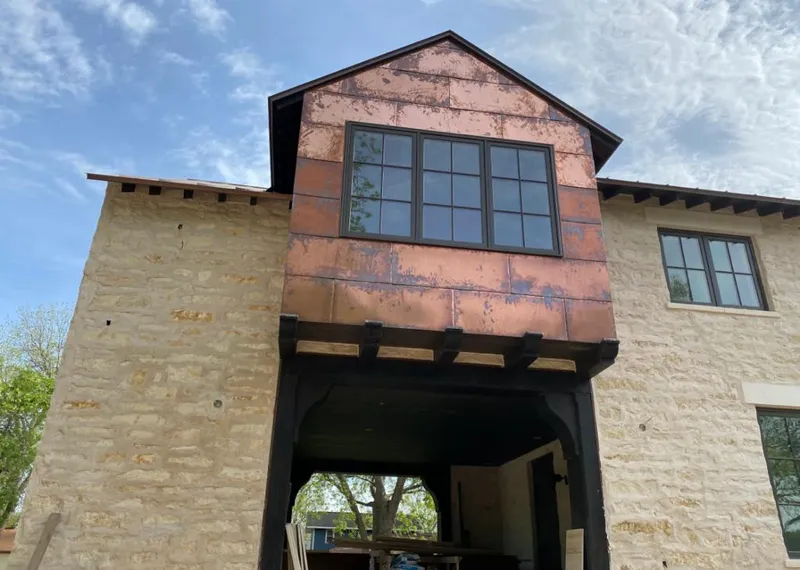 Copper metal panel facade on a stone building for Skylight Installation in Gaffney